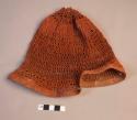 Man's head net decorated with red clay (ugulasu)