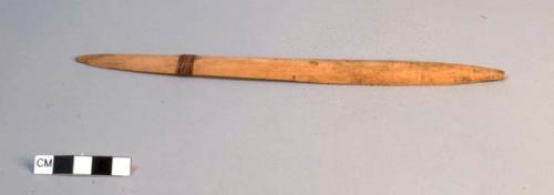 Little wooden stick for flicking seeds in boy's game