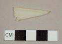 Cream-colored plastic cutlery fragment