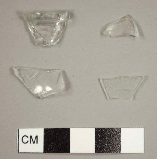 Colorless bottle glass fragments, includng one narrow lip fragment