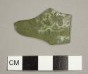 Olive green flat glass fragment, possibly from a window or casement bottle