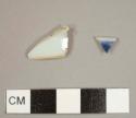 Porcelain sherds, one plain-glazed bowl footring and one plate rim fragment with blue decoration on interior