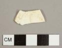 Refined, white earthenware sherd with no glaze remaining