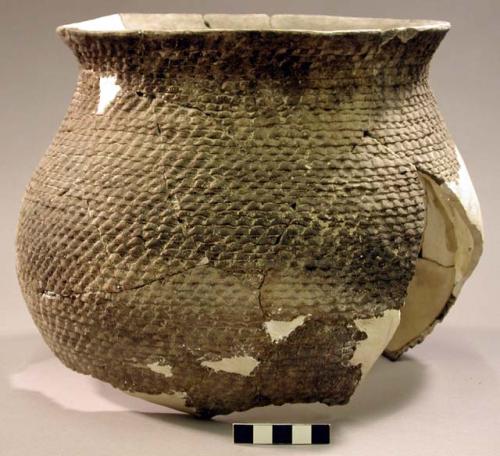 Corrugated pottery jar--restorable?