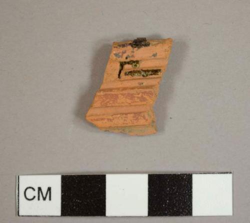 Lead-glazed red earthenware sherd with ridges on one side