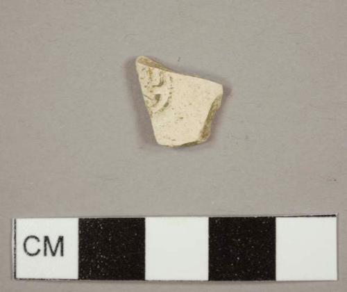 Kaolin/White ball clay pipe bowl fragment with part of a stamp remaining and the letter "D" visible