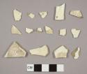 Creamware sherds, including four plate rim sherds and one with a molded feather pattern