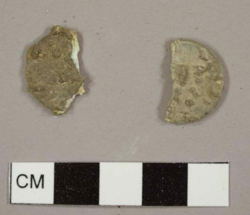 Two oxidized, fragmented pennies
