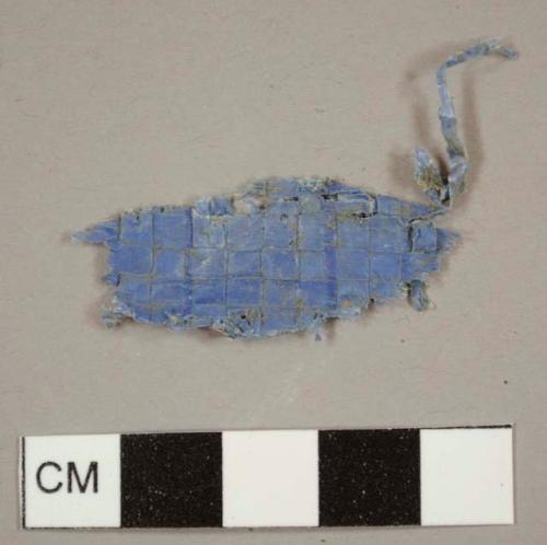 Blue plastic woven tarp fragment