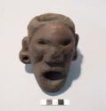 Cast of effigy pipe bowl, human head with ear gauges