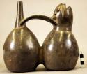 Pottery double spouted whistling seal figure