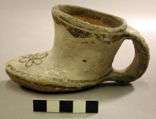 Brown on white pottery shoe