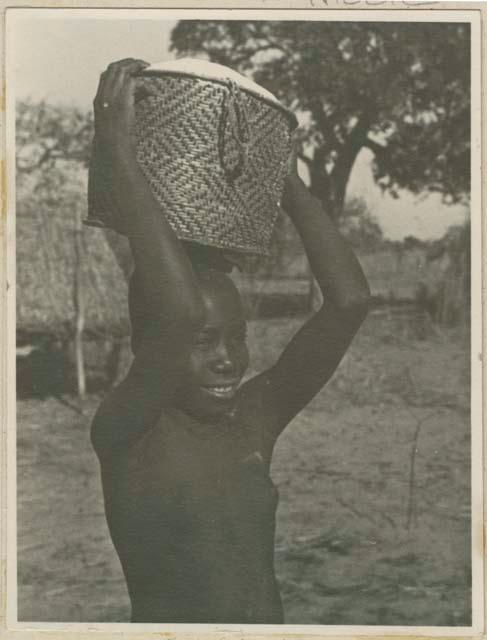 Woman carrying grain basket