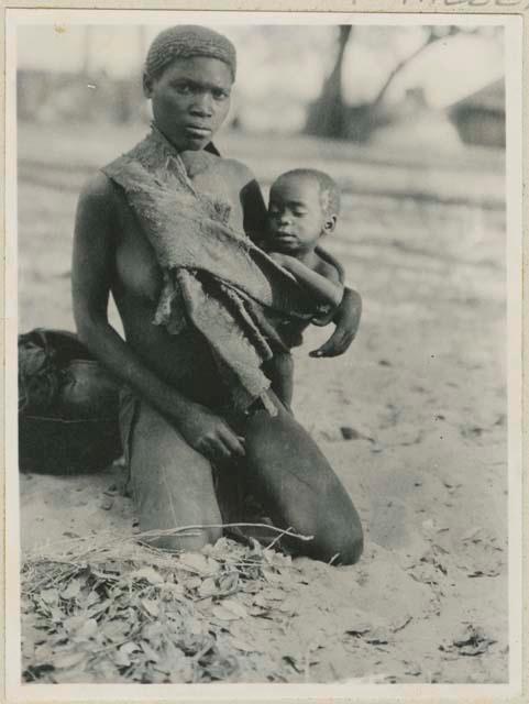 Woman with baby in a sling of bark cloth