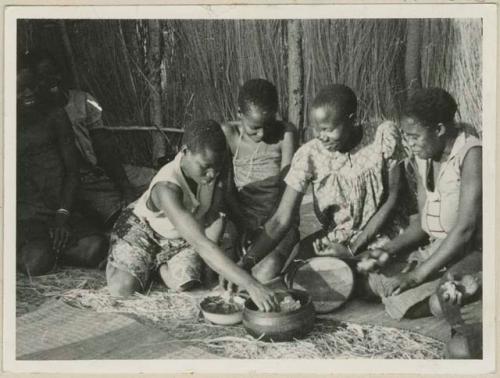 Group of women with wooden bowl