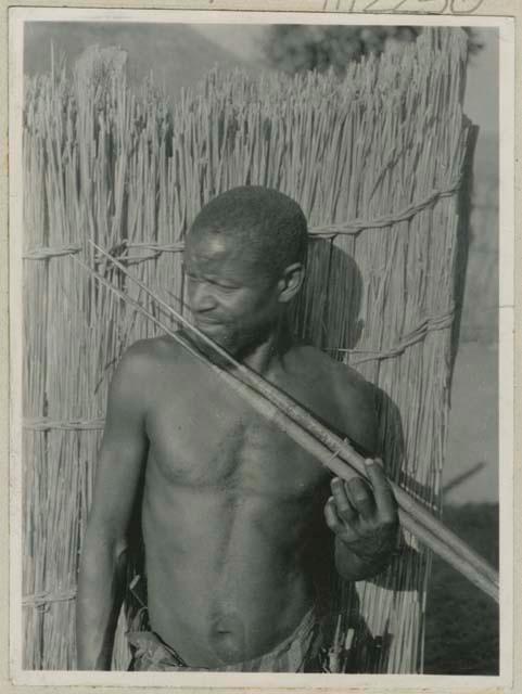 Man holding fish spears