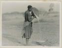 Woman winnowing grain