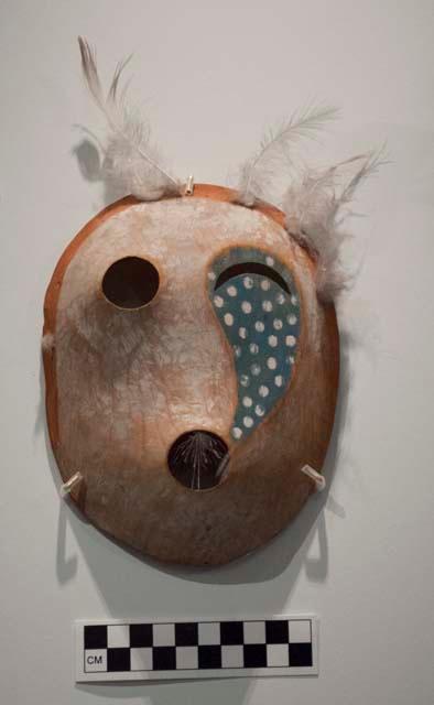 Spirit mask. Crescent-shaped and round eyes, red-painted groove around edges.