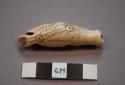 Ivory toggle. Holes in toggle suggest its use as an amulet to be hung.
