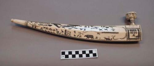 Pipe of walrus ivory. Bowl dovetailed into top of deep end w/ geometric designs.