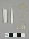 White and colorless plastic fragments, including a fork tine and handle fragment