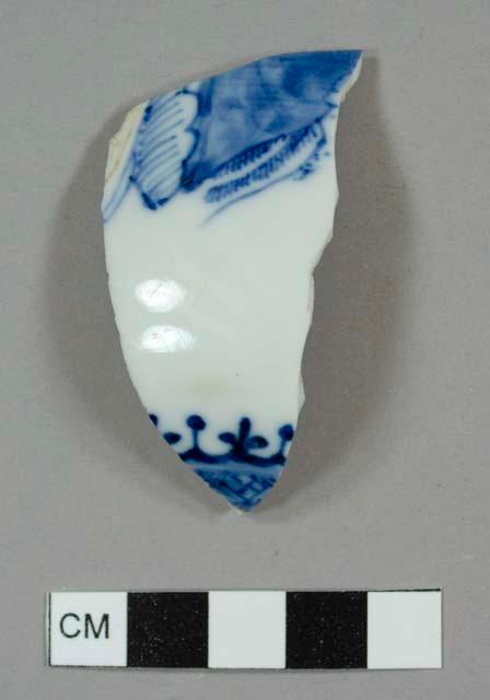 Asian porcelain teapot body sherd with the base to the spout and a hand-painted blue-on-white design