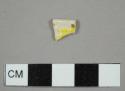 Creamware rim sherd with yellow and brown bands on interior