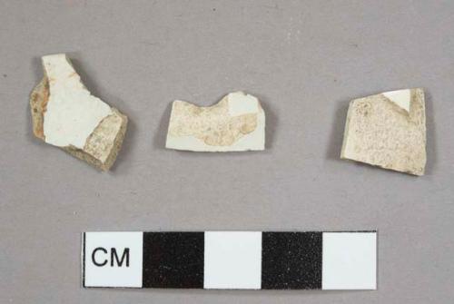 Two pearlware sherds, including one plate rim sherd, and one creamware sherd