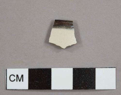 White, salt-glazed stoneware bowl sherd with brown lustrous glazed rim