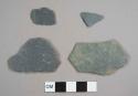 Slate pieces, including one with mortar fragments on one side, possibly from foundation or pathway