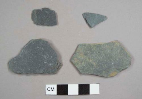 Slate pieces, including one with mortar fragments on one side, possibly from foundation or pathway