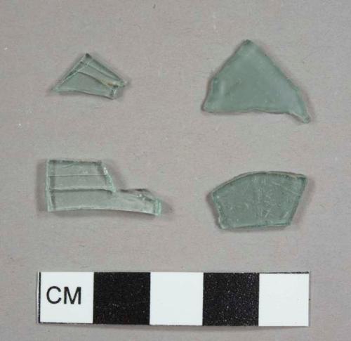 Aqua flat glass fragments, including one frosted fragment