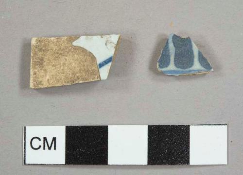 Tin-glazed buff earthenware sherds with hand-painted blue decoration