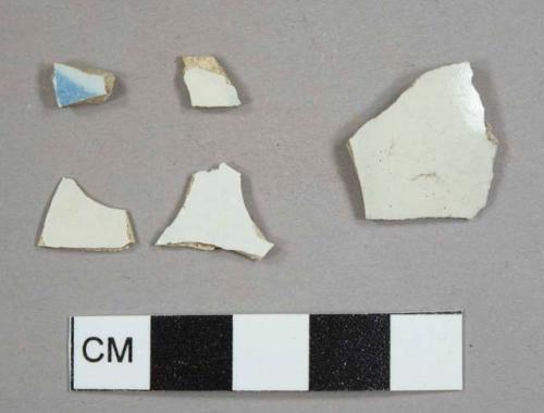 Four pearlware sherds, one with blue decoration, and one white salt-glazed stoneware sherd