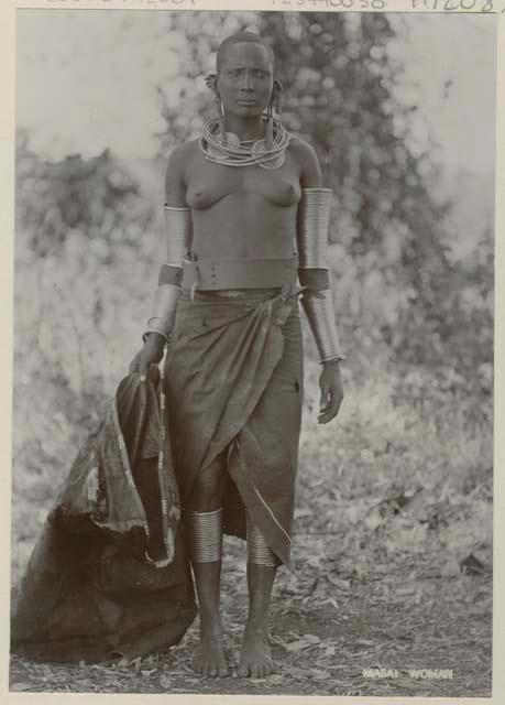 Woman standing and holding a large bag or garment