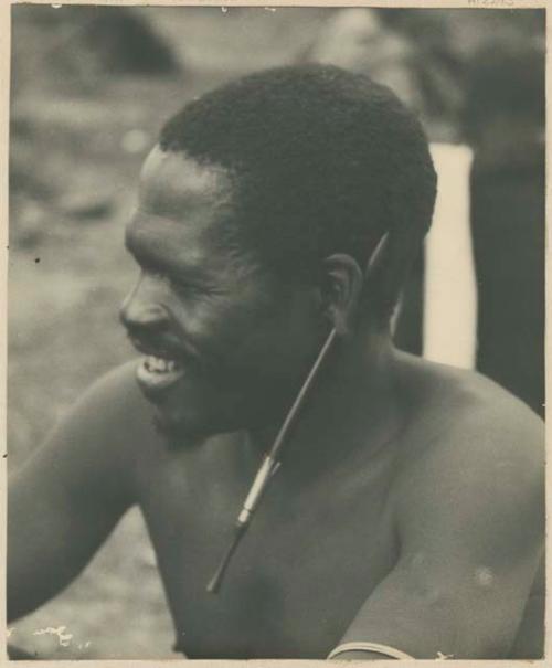 Man with snuff tube through ear