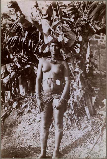 Woman standing in front of a large plant