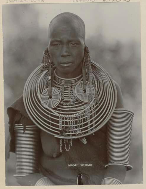 Woman with metal neck and arm rings