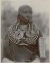 Woman with metal neck and arm rings