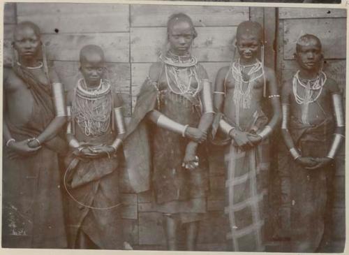 Group of girls standing in front of a structure