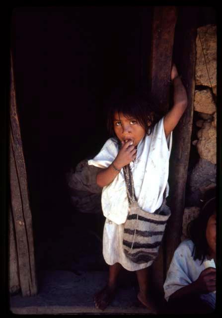 Ika child in doorway
