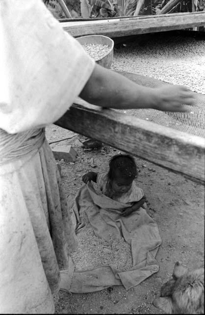 Ika woman and child with corn and mortar
