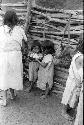 Ika children in corral drinking milk








