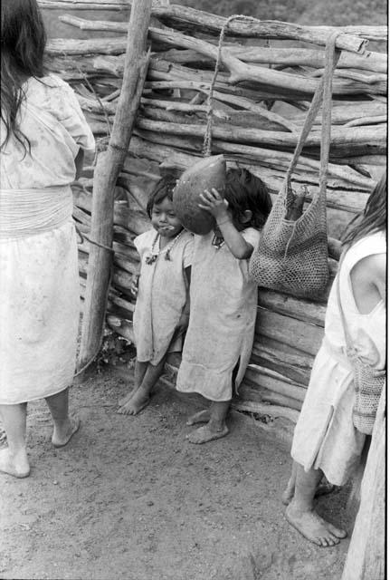 Ika children in corral drinking milk








