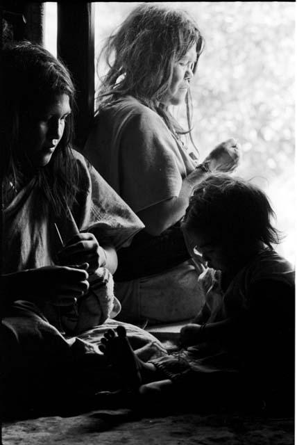 Ika women sewing hats


