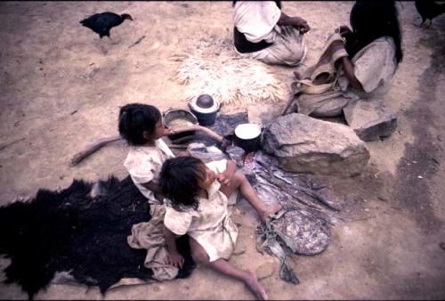 Two Ika children near fire
