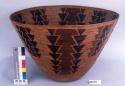 Large, stiff, finely-coiled basket with flaring sides. Geometric decoration