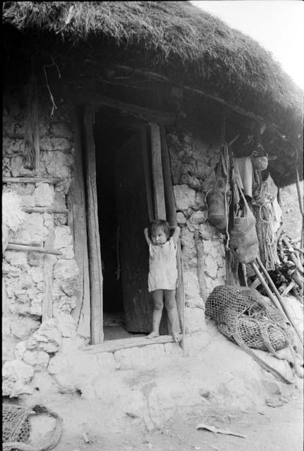 Ika child in doorway




