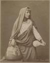 Studio portrait of a woman with a large ceramic vessel