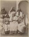 Group of women sitting in front of a building